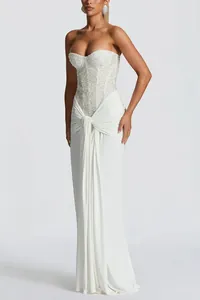 Elegant white strapless evening dress featuring a beaded corset bodice and draped front