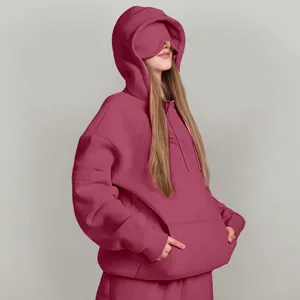 Oversized maroon hoodie with unique built-in eye mask detail for cozy travel comfort