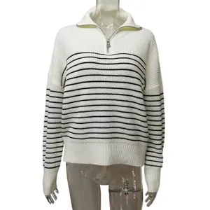 Close-up of white and black striped knit sweater for women with half-zip polo collar