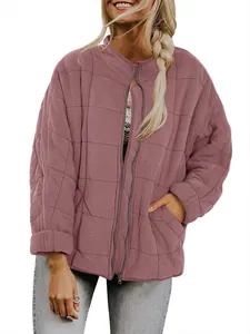 Detail view of women's dusty rose quilted jacket featuring stand collar and zipper closure.