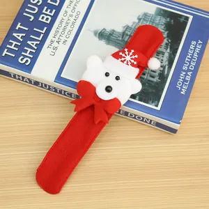 Detail view of a red Christmas slap bracelet featuring a cute white polar bear ornament