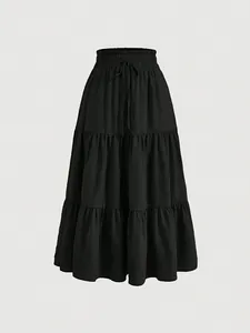 Detailed view of black tiered cake skirt with elastic drawstring waist and textured fabric