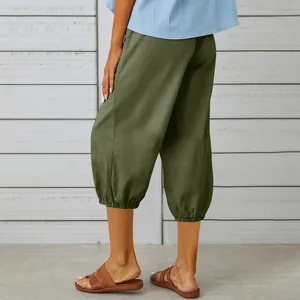 Back view detail showing the fit and elastic cuffs of olive green cotton linen pants