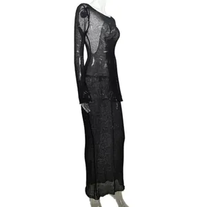 Detailed side view of a black sheer knitted maxi dress with long sleeves and scoop neck.