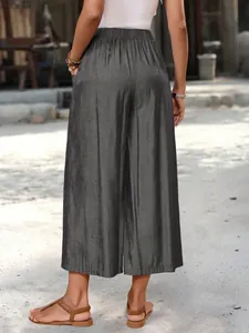 Back view of women's loose grey wide-leg culottes featuring elastic waist and pockets.
