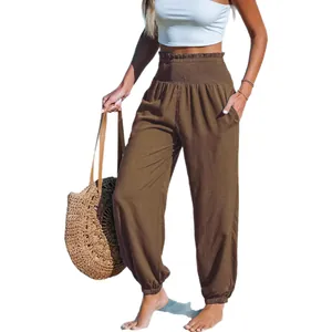 Women's brown high-waisted loose beach pants with smocked elastic waist and cuffed hem