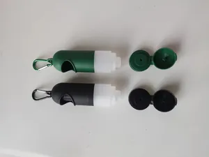 Detailed top-down view of portable pet waste bag dispensers in green and black with open caps