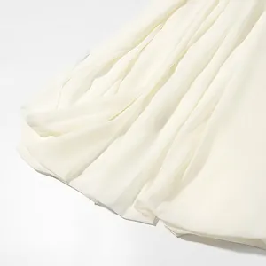 Close-up detail of flowing white chiffon fabric with soft elegant drapes