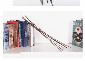Durable brown floral arrangement stems leaning against decorative books for home decoration