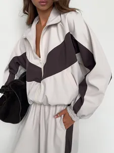Detailed view of a women's cream and brown color-block tracksuit set.