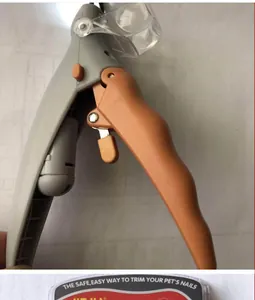 Close-up detail of pet nail clipper featuring integrated LED light and safety guard
