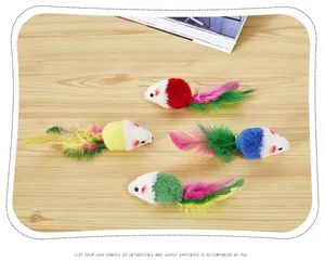 Detail view of colorful plush cat toy mice with vibrant feather tails on wood background