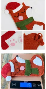 Detailed view of a cute fox Christmas stocking being weighed at 15g for shipping.
