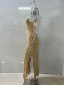 Side profile of a sexy gold knitted bodycon dress featuring a high side slit on a mannequin