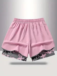 Detail of pink 2-in-1 athletic shorts with inner pixel camo lining and elastic waist.