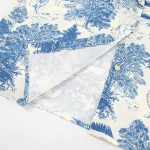 Detailed close-up showing blue toile de jouy landscape print and buttons on a linen shirt