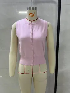 Pink sleeveless knitted button-up vest top with a round neck displayed on a mannequin