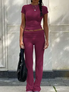 Two-piece burgundy workout set featuring a crew neck T-shirt and low waist flare pants