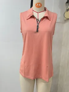 Macro detail of women's coral pink ribbed knit tank top with zipper and polo collar