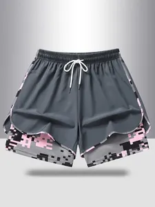 Close-up view of women's 2-in-1 sports shorts with pink pixel pattern and white drawstring.