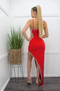 Close-up back view of a red sling dress with hot diamonds and sheer mesh panel.