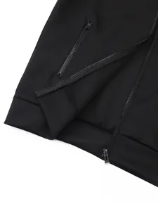 Detailed close-up of a black sports jacket featuring metal zippers and ribbed hem
