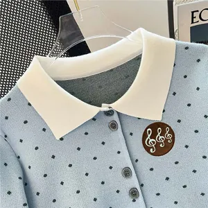 Elegant light blue polka dot knitted cardigan with white collar and musical badge