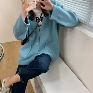 Oversized light blue knitted cardigan featuring V-neck and functional front pockets