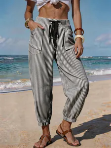 Detail view of women's striped linen-like joggers with drawstring for beach vacation