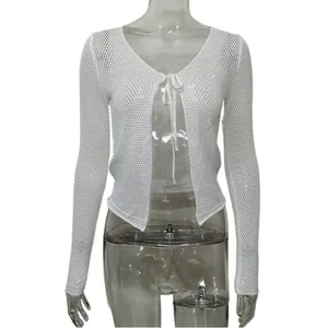 Detailed view of the white hollow-out knit cardigan with front tie-up bow design