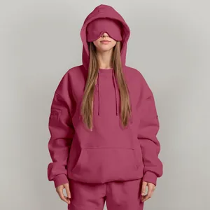 Detailed view of mauve oversized pullover hoodie with an innovative built-in sleep mask