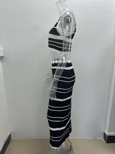 Side view detail of a chic black and white striped knitted crop top and maxi skirt set for women.