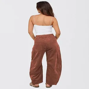 Back view of women's high waisted rust corduroy loose straight leg autumn trousers