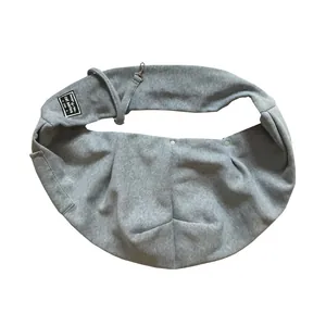 Detailed view of a grey pet sling carrier bag with adjustable strap and snap buttons.