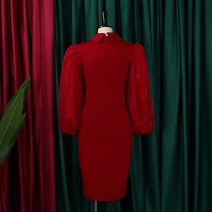 Back view of elegant red pencil dress with sheer mesh puff sleeves on mannequin