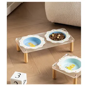 Detail view of flower-shaped ceramic pet bowls on a transparent acrylic stand with wood legs