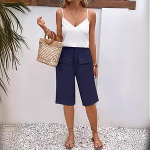 Full view of the navy blue loose shorts showing the drawstring waist and button pockets.