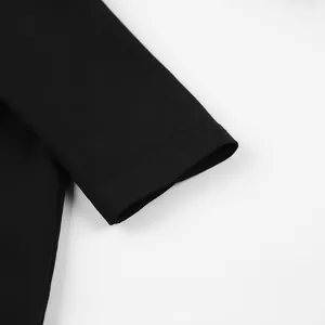 Close-up detail of the sleeve cuff on a French style long-sleeved black dress