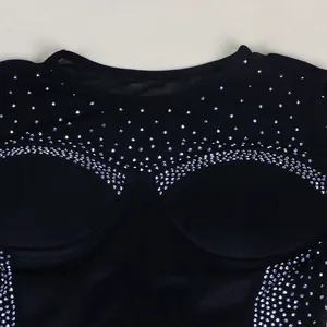 Macro detail of sparkling rhinestone embellishments on a black mesh bodycon dress