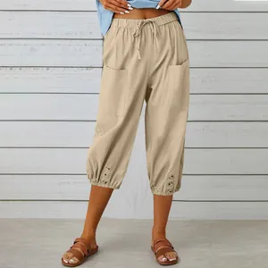 Detail view of cotton linen cropped pants with drawstring waist and buttoned hems.