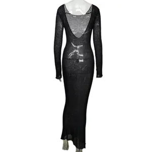 Detailed view of sheer black long-sleeved backless knit dress with metallic shimmer.