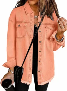 Close-up detail showing the frayed raw hem of this peach orange washed denim shirt jacket