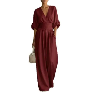 Elegant burgundy women's V-neck jumpsuit with a cinched high waist and wide-leg trousers