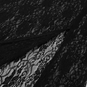 Macro shot showing the intricate floral pattern and texture of black lace on a summer dress.