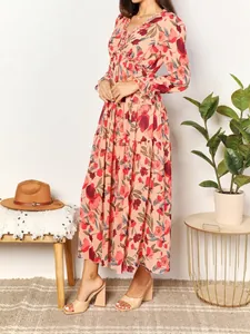 Elegant bohemian long-sleeved floral print maxi dress featuring a tiered ruffled skirt
