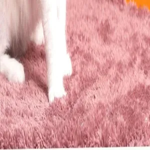 Macro detail showing soft pink long plush texture of cat mat with white kitten paws