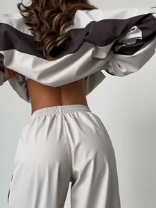 Back view of chic color-blocked tracksuit with light beige and brown detailing.