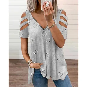 Close-up detail of gray V-neck T-shirt featuring zipper and silver heart pattern print