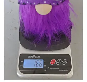 Halloween purple plush gnome doll weighing approximately 166 grams on a digital scale