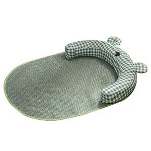 Breathable pet cooling mat with green gingham bolster for summer sleeping.